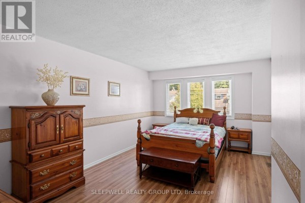 Bedroom with wooden furniture and wood-style flooring - 31 Tamblyn Crescent Ottawa