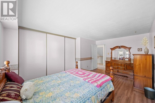 Bedroom with wood floor, dresser with mirror, and closet - 31 Tamblyn Crescent Ottawa
