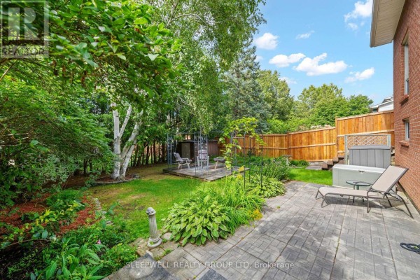 Backyard with hot tub, lounge chair, gazebo, deck, and landscaping - 31 Tamblyn Crescent Ottawa