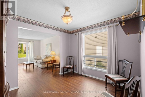 Living room with hardwood floors and sofa overlooking a sitting area - 31 Tamblyn Crescent Ottawa