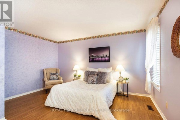 Bedroom with queen bed, armchair, and lavender walls - 31 Thames Drive N Whitby