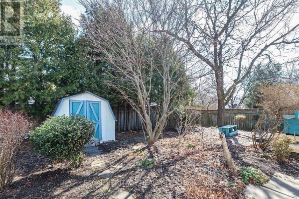 Backyard with shed, deck, and trees - 31 Thames Drive N Whitby