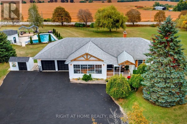 Overhead aerial view of the white bungalow, showcasing the pool and surrounding fields. - 31 Uxbridge Heights Drive, Brock