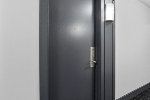 A close-up view of a dark gray apartment door with a silver handle and number 30. - 310 - 1070 Sheppard Avenue W, Toronto