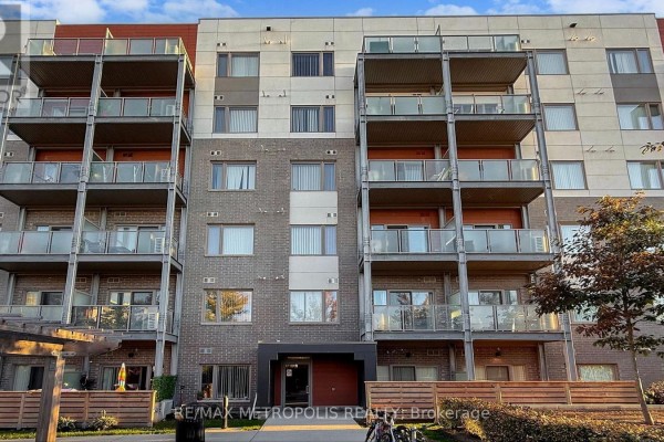 Close-up of the facade of a condominium building with brick and modern paneling. - 310 - 20 Orchid Place Drive, Toronto