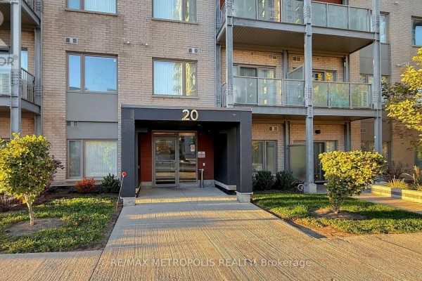 Entrance to condominium building 20 Orchid Place Drive with a paved walkway and landscaping. - 310 - 20 Orchid Place Drive, Toronto