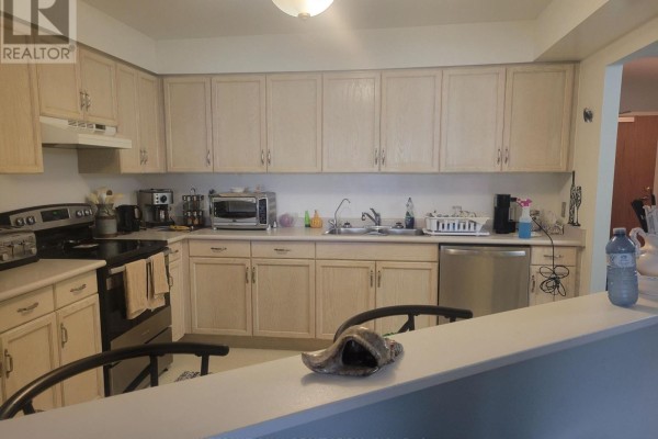 Apartment kitchen with light wood cabinets, stainless steel appliances, and a sink. - 310 - 85 Wellington Street W, Aurora