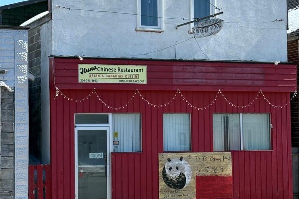 Red exterior of Ituna Chinese Restaurant with "Chinese Food" sign and string lights. - 310 Main Street N, Ituna
