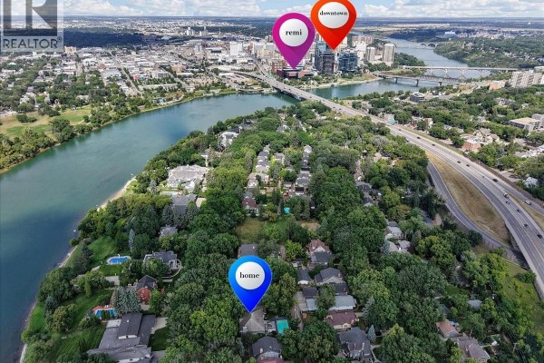 Aerial view of Saskatoon showing the river, bridge, downtown, and residential areas with map pins. - 310 Saskatchewan Crescent W, Saskatoon