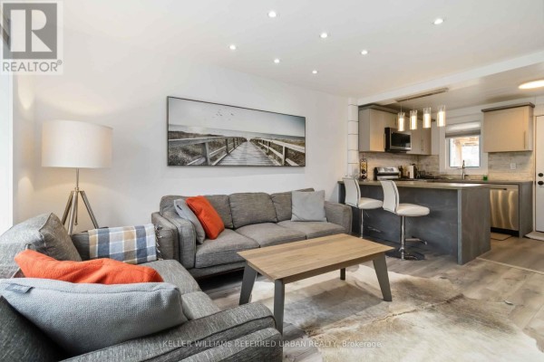 Kitchen with grey countertops, stainless steel appliances, and white subway tile backsplash. - 310 Senlac Road, Toronto