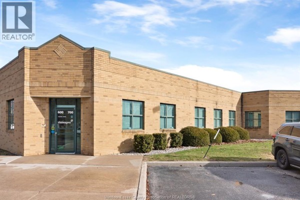 Side view of the commercial building featuring brick exterior and landscaped area - 3100 Temple Drive, Windsor