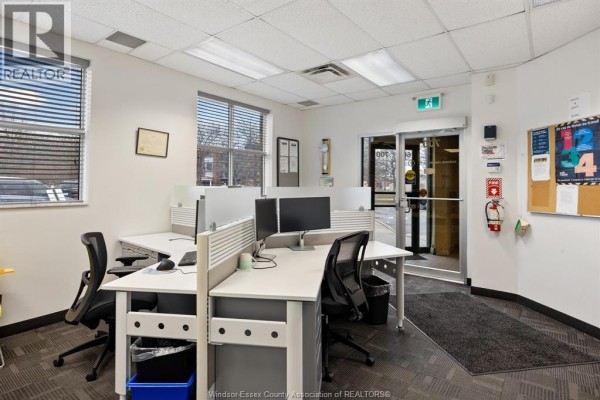 Interior office space with desks, computers, and large windows for natural light - 3100 Temple Drive, Windsor