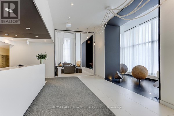 Reception desk and lobby area with contemporary seating and decorative spheres. - 3102 - 20 Richardson Street, Toronto