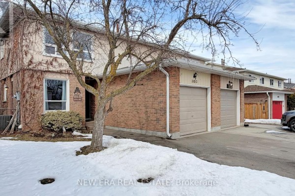 Another angle of the entryway with a wooden sideboard and door to the outside. - 3103 Autumn Hill Crescent, Burlington