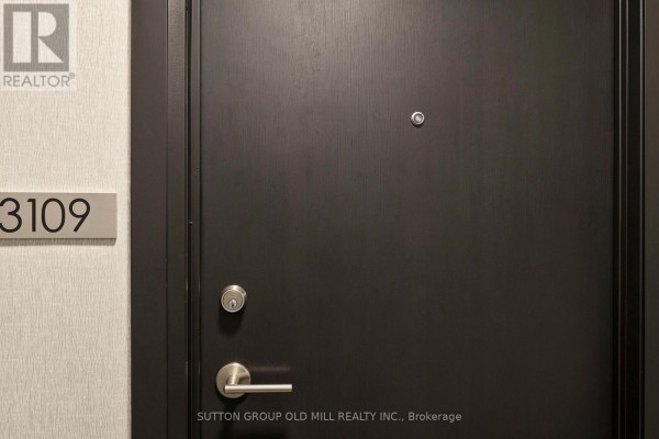 Close-up of a dark wooden apartment door with unit number 3109 and modern hardware. - 3109 - 3504 Hurontario Street, Mississauga