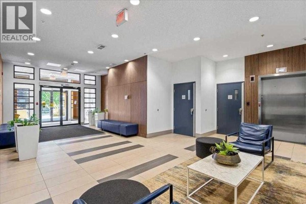 Lobby entrance featuring modern seating, plants, and an elevator - 311, 510 Edmonton Trail Ne, Calgary