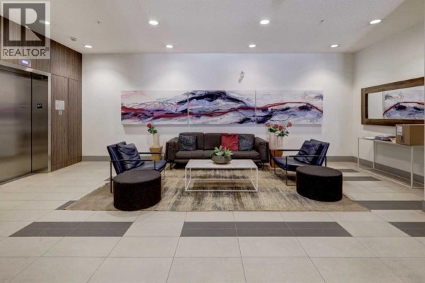 Lounge area with seating, artwork, and coffee table - 311, 510 Edmonton Trail Ne, Calgary