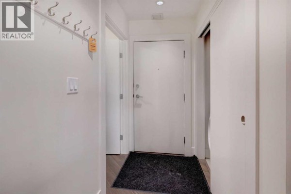 Entryway with coat hooks, door, and welcome mat - 311, 510 Edmonton Trail Ne, Calgary