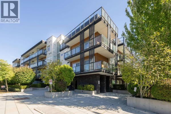 Exterior of a modern apartment building with balconies and a small playground. - 311 12070 227 Street, Maple Ridge