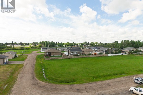 View of the vacant lot at 311 Ead Road, Mclean, bordered by residential homes and trees. - 311 Ead Road, Mclean