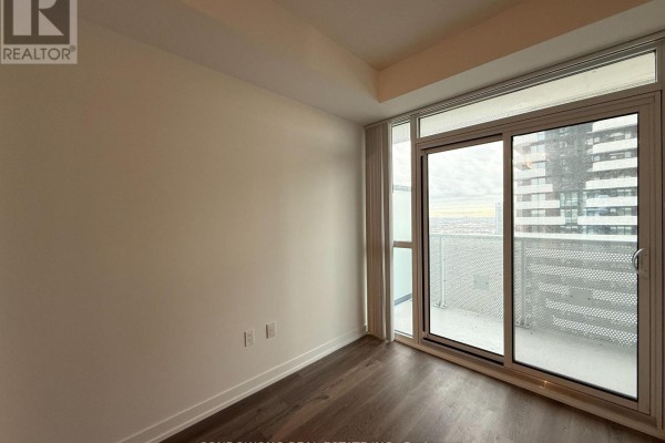 Bedroom with large sliding glass doors to balcony and city view. - 3115 - 225 Commerce Street, Vaughan