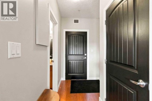 Interior hallway with two black paneled doors and a white light switch plate. - 3117, 135c Sandpiper Road, Fort Mcmurray