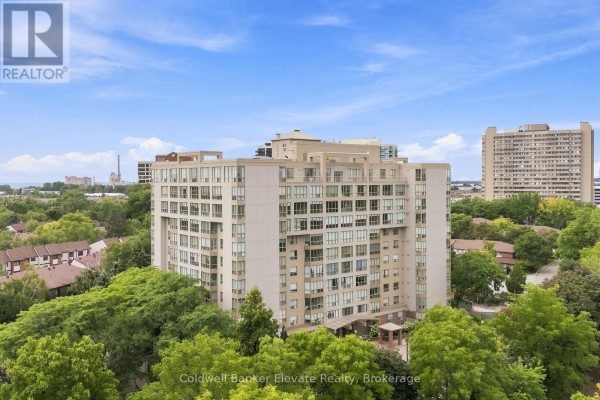 Exterior view of the apartment building at twilight with many windows illuminated. - 312 - 1110 Walden Circle, Mississauga