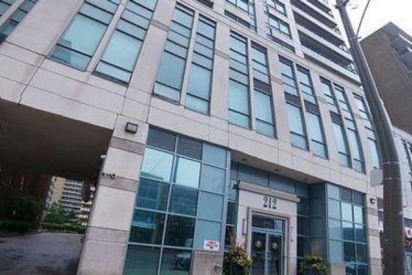 Exterior view of apartment building at 212 Eglinton Avenue East with concrete and glass facade. - 312 - 212 Eglinton Avenue E, Toronto