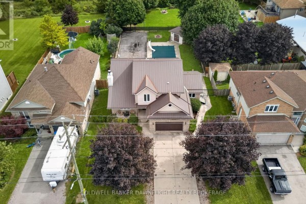 Aerial view of 312 Beech Street showing the house, backyard pool, and surrounding properties. - 312 Beech Street, Lucan Biddulph