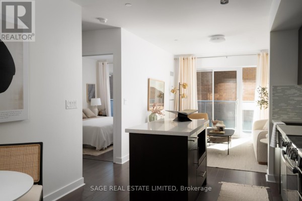 View from kitchen island through open doorway to bedroom and living room. - 313 - 58 Orchard View Boulevard, Toronto