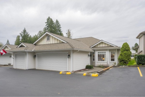 Gated entrance to the community with fountain and surrounding trees - 313 20655 88 Avenue, Langley