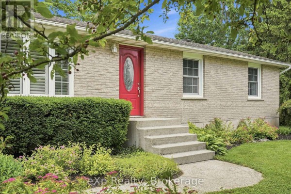 Close-up of the red front door with glass inserts and concrete steps on a brick house. - 313 Bruce 15 Road, Brockton