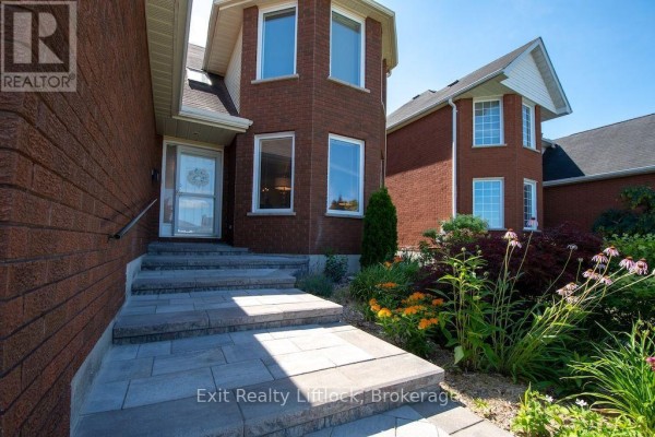 Stone walkway and steps leading to the front entrance of a brick house. - 3133 Frances Stewart Road, Peterborough