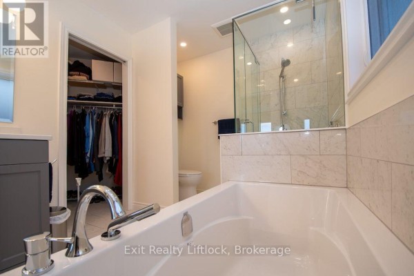 Soaking tub, glass shower, and walk-in closet in bathroom - 3133 Frances Stewart Road Peterborough