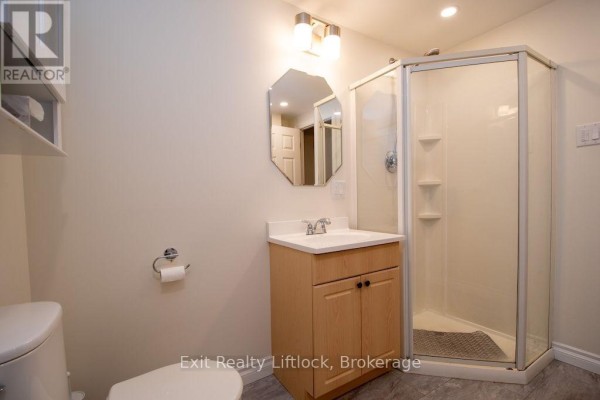 Bathroom with vanity, corner shower, and octagonal mirror - 3133 Frances Stewart Road Peterborough