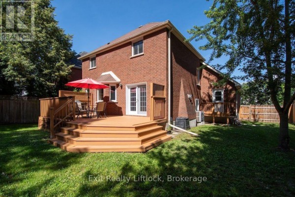 Wooden deck with furniture and umbrella - 3133 Frances Stewart Road Peterborough