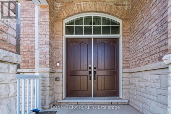 Close-up of dark brown double front doors with arched transom window above. - 3136 Ernest Appelbe Boulevard, Oakville