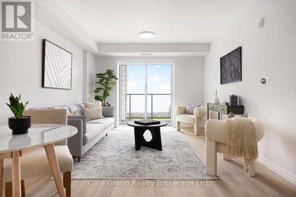 Living room with furniture, rug, and a large sliding glass door with a view of the landscape. - 314 - 425 Watson Parkway N, Guelph