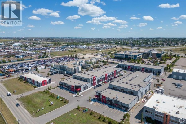 Aerial view of a commercial development with multiple buildings and surrounding urban landscape. - 3140, 6520 36 Street Ne, Calgary