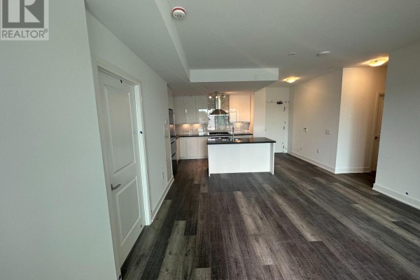 View of the kitchen island and white cabinetry from the living room. - 314a - 11782 Ninth Line, Whitchurch Stouffville