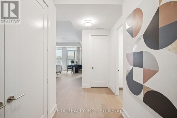 Hallway with light wood floors, white doors, and a large abstract painting on the right wall. - 315 - 399 Royal Orchard Boulevard, Markham