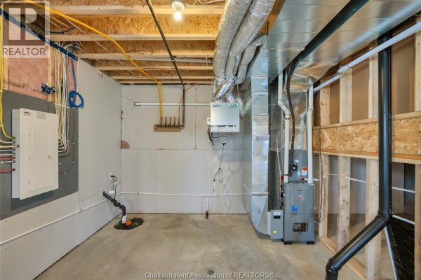 Furnace, water heater, sump pump, and ductwork in unfinished basement - 315 Ironwood Trail Chatham