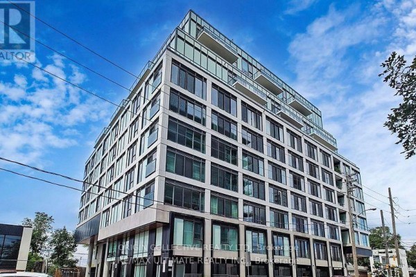 Close-up view of a contemporary condo building with glass balconies and concrete facade. - 316 - 1195 The Queensway St, Toronto