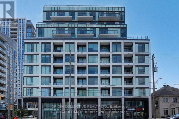 Front facade of a multi-story condo building with repeating glass windows and balconies. - 316 - 1195 The Queensway St, Toronto