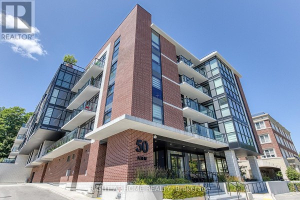 Close-up of the modern brick and glass apartment building exterior with balconies. - 316 - 50 Ann Street, Caledon