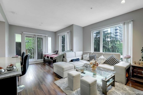 View from window showing green trees and adjacent building. - 316 13339 102a Avenue, Surrey
