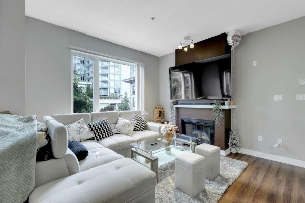View from window showing tall apartment buildings and trees. - 316 13339 102a Avenue, Surrey