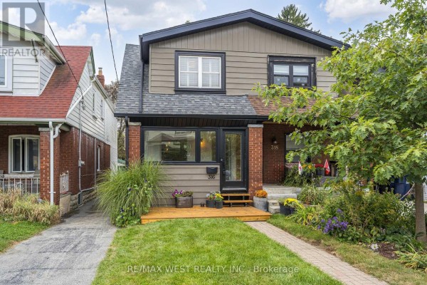 Exterior view of the house at 316 Monarch Park Avenue, Toronto with landscaping. - 316 Monarch Park Avenue, Toronto