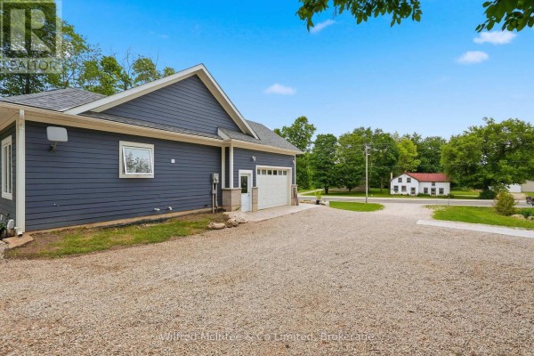 Blue sided house with garage and gravel driveway - 316040 6 Highway Chatsworth
