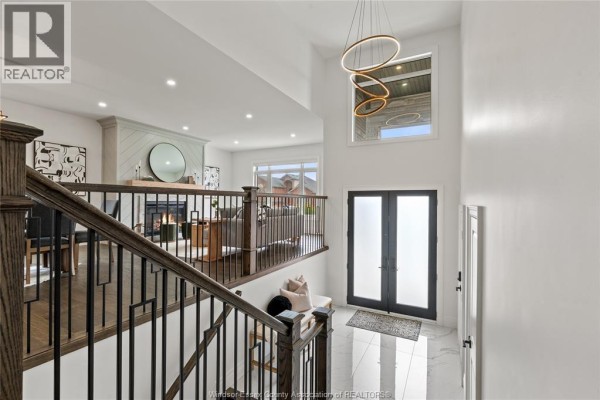 Open concept living and dining area with a large dining table and a gas fireplace. - 3161 Mcrobbie, Windsor